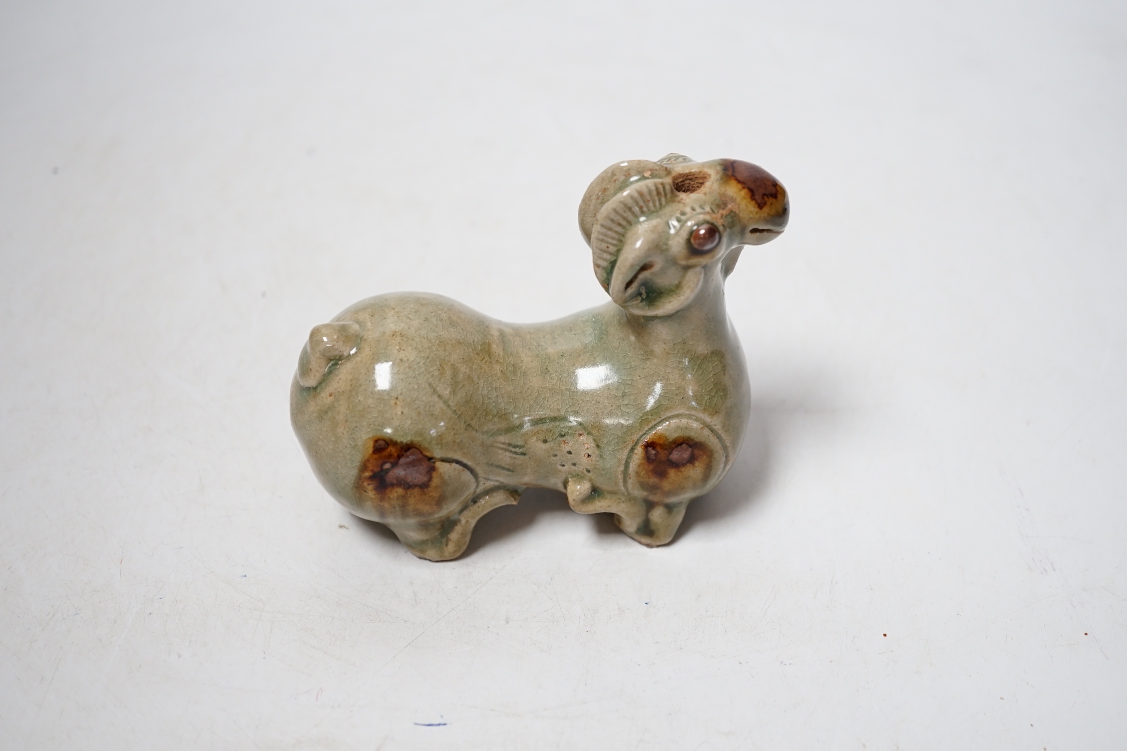 A Chinese Yue type green glazed model of a ram, 10cm wide
